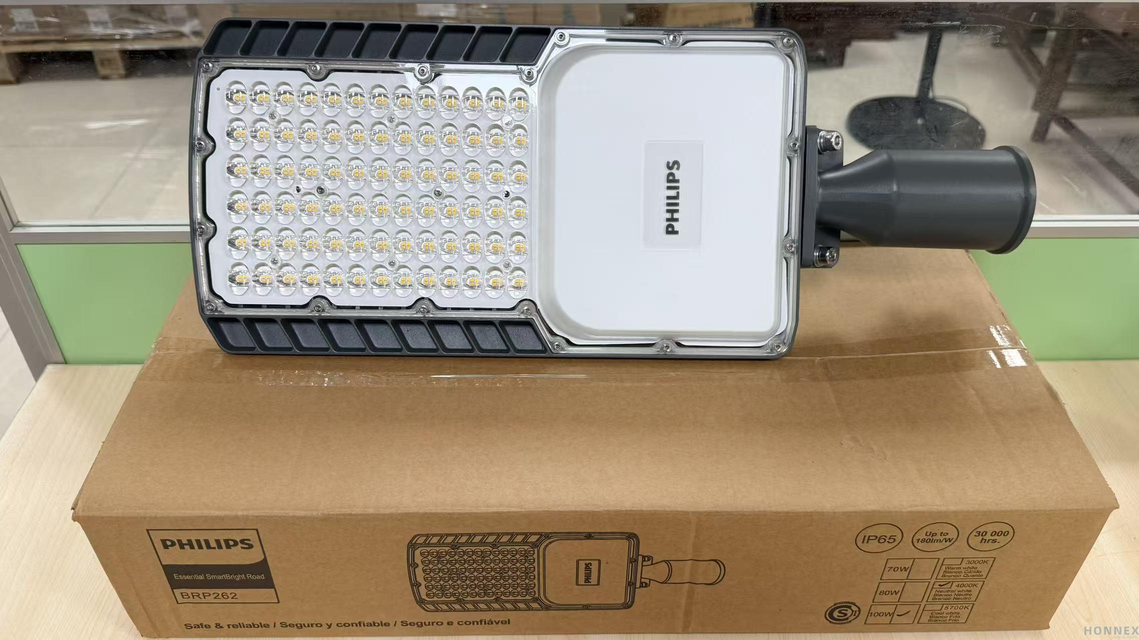 PHILIPS BRP262 SmartBright LED Road Light 100W — real warehouse photo showing LED array, PHILIPS badge and side-entry spigot