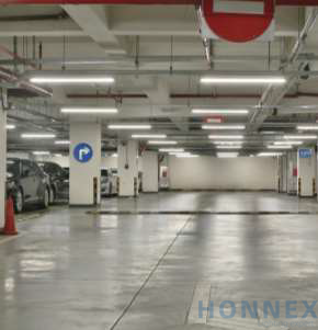 PHILIPS MASTER UltraEfficient T5 LED tubes installed in an underground parking garage, providing bright uniform overhead illumination