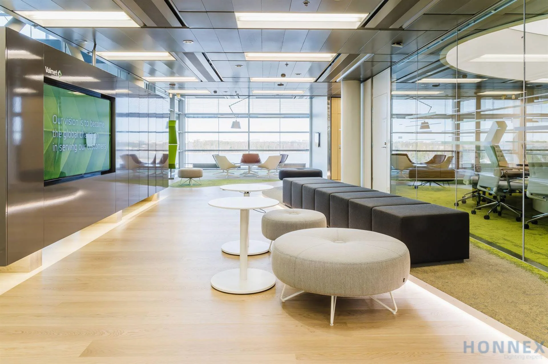 Aura RC430 indirect/direct panels installed in a suspended ceiling of an open office lounge