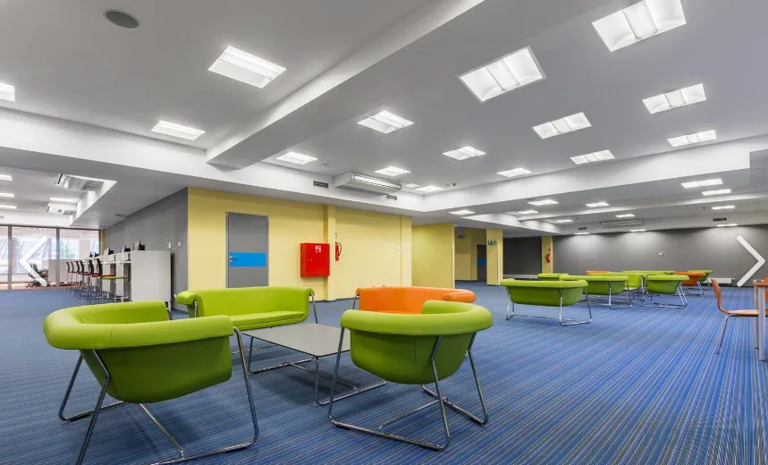 Open office meeting area lit by Aura RC430 indirect and direct LED panels